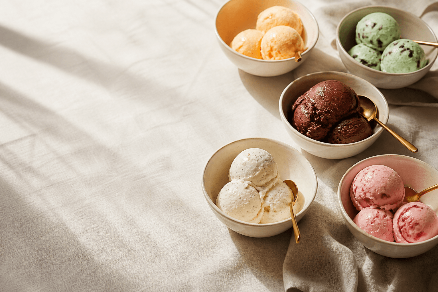 Bowls of QC Cream ice cream on a cream linen table